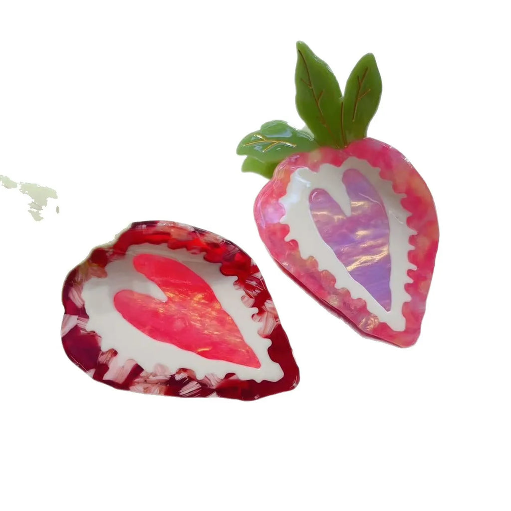 A red or pink hairpin featuring a sweet strawberry fruit design in a pastoral style.