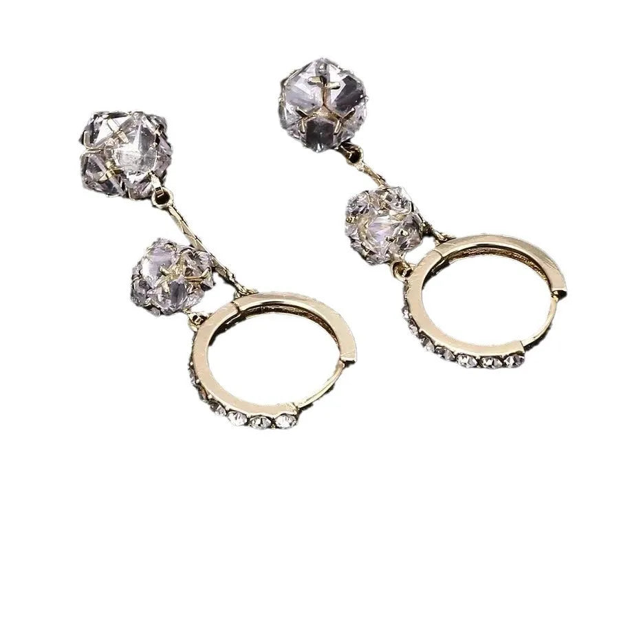 Silver drop earrings for women with a tassel ball and rhinestone ball pendant design.