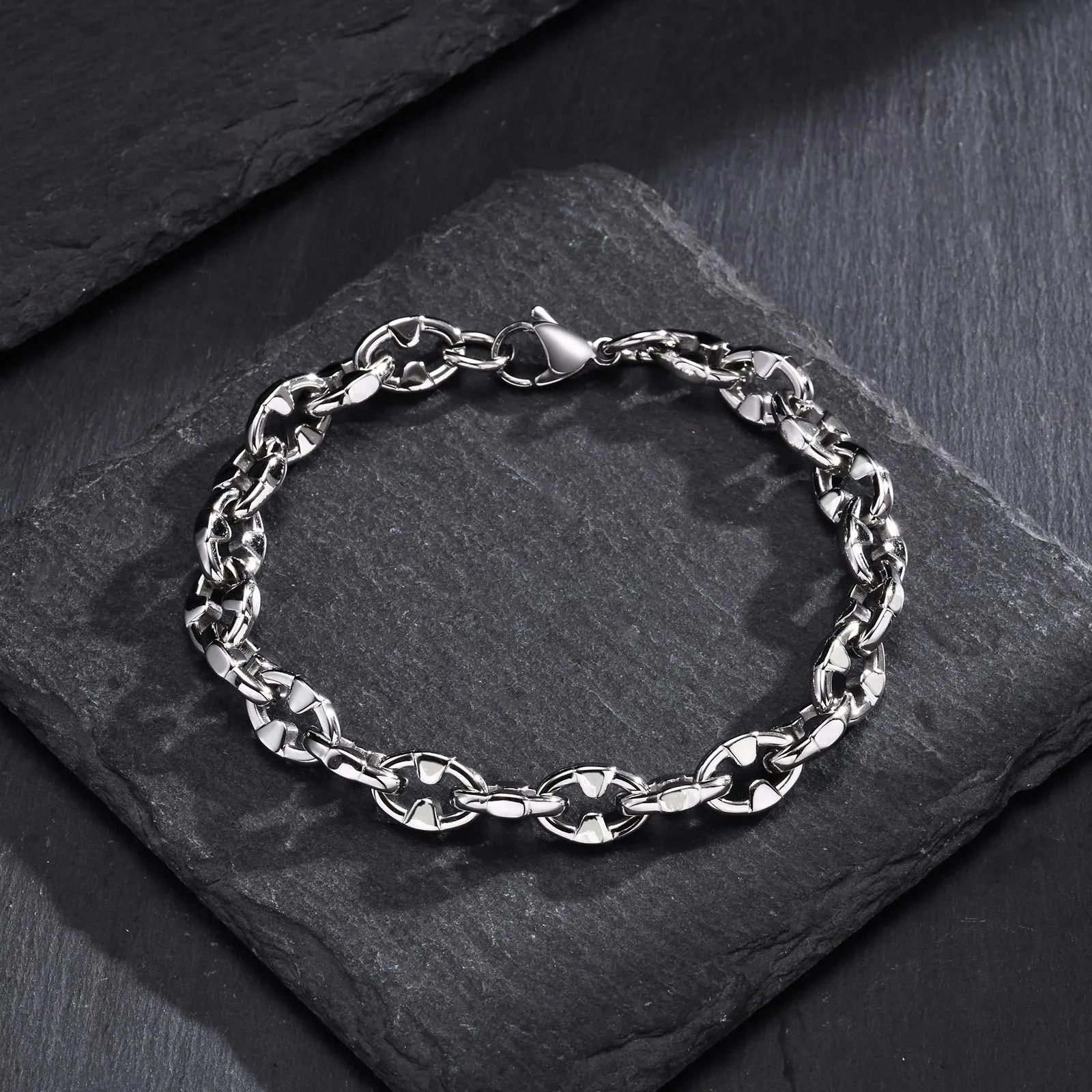 A thick stainless steel chain bracelet with geometric links, shown in a steel colour.