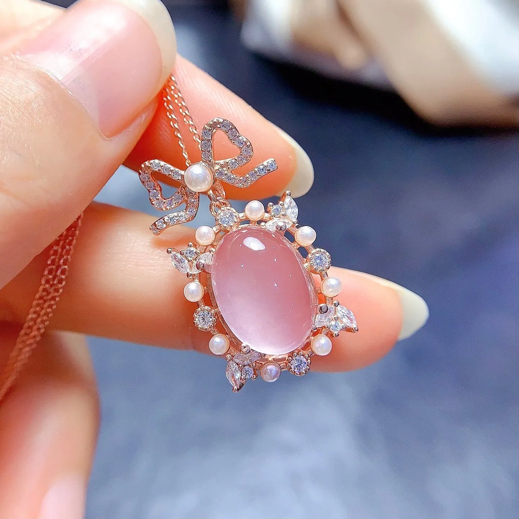 Rose quartz geometric pendant on a silver chain with rose gold plating.
