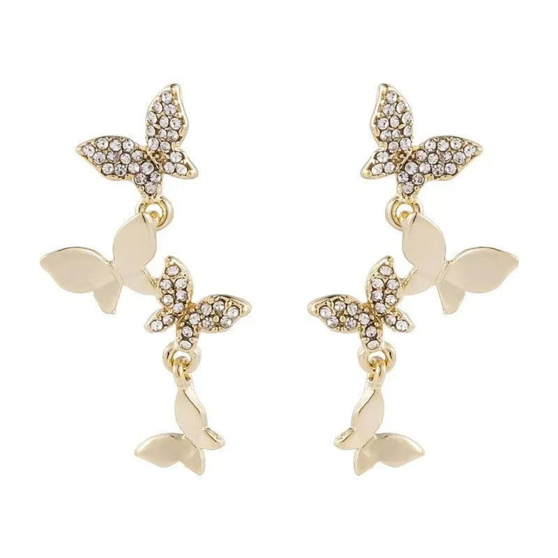 Gold-coloured copper butterfly drop earrings showing four butterfly designs