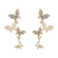 Gold-coloured copper butterfly drop earrings showing four butterfly designs