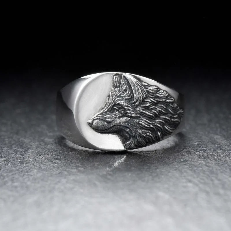 Silver alloy men's ring with a geometric wolf design on a black background.