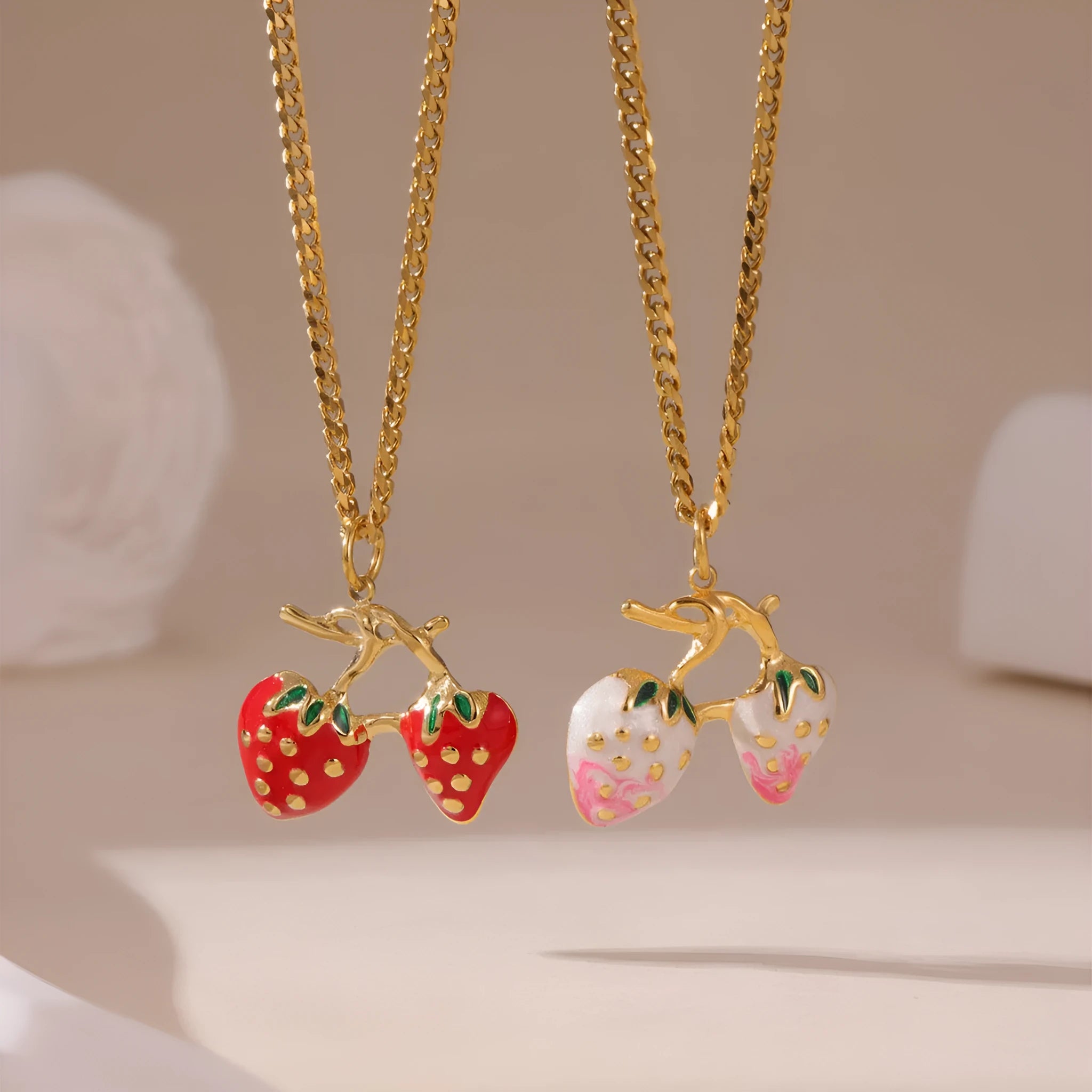 Women's strawberry fruit pendant necklace in red and white gradient colours on an alloy chain.