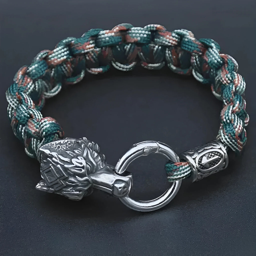 Handmade titanium steel wolf head bracelet in camouflage colour on a wrist.