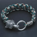 Handmade titanium steel wolf head bracelet in camouflage colour on a wrist.