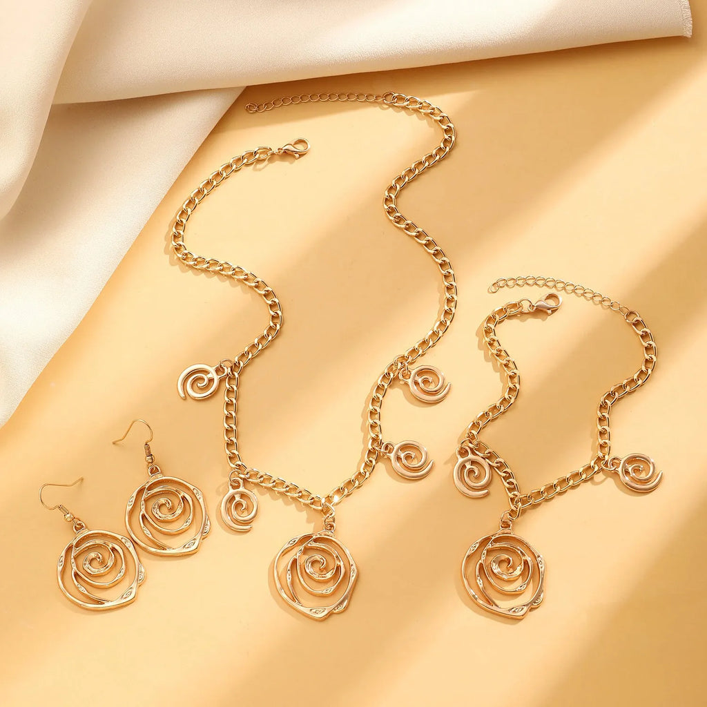 Spiral donut design women's jewellery set showing necklace, bracelet and ear hooks in gold or silver finish