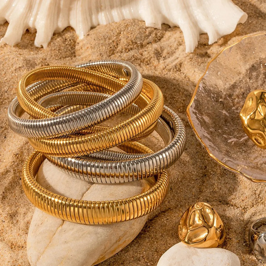 Women's titanium steel bracelet with vertical stripe pattern in gold or silver, available in 0.8cm to 2.0cm widths
