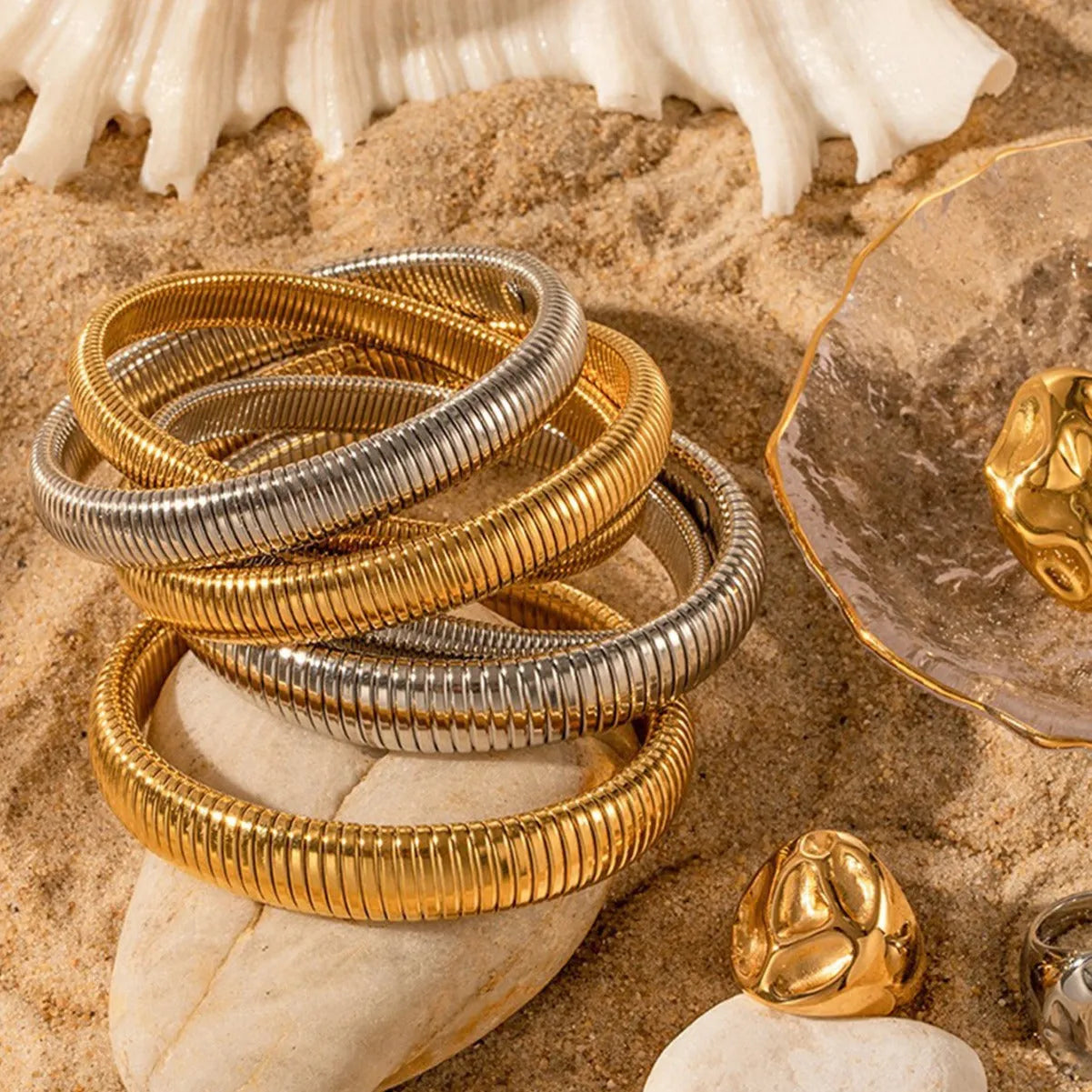 Women's titanium steel bracelet with vertical stripe pattern in gold or silver, available in 0.8cm to 2.0cm widths