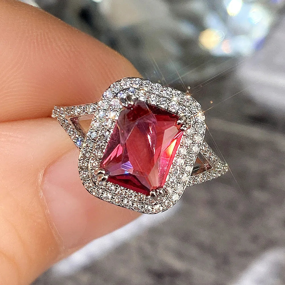 Red copper square women's ring with a central rhinestone on a model's hand.