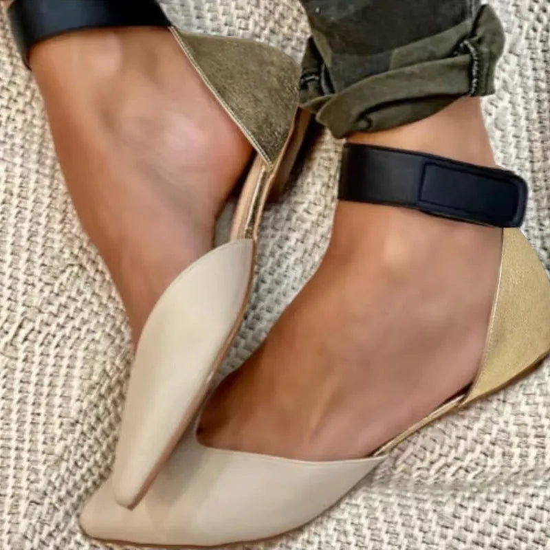 Women's beige velcro sandals with hollowed design and flat heel on wooden floor