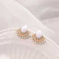 Women's silver geometric fan-shaped stud earrings with a central rhinestone on a white background.