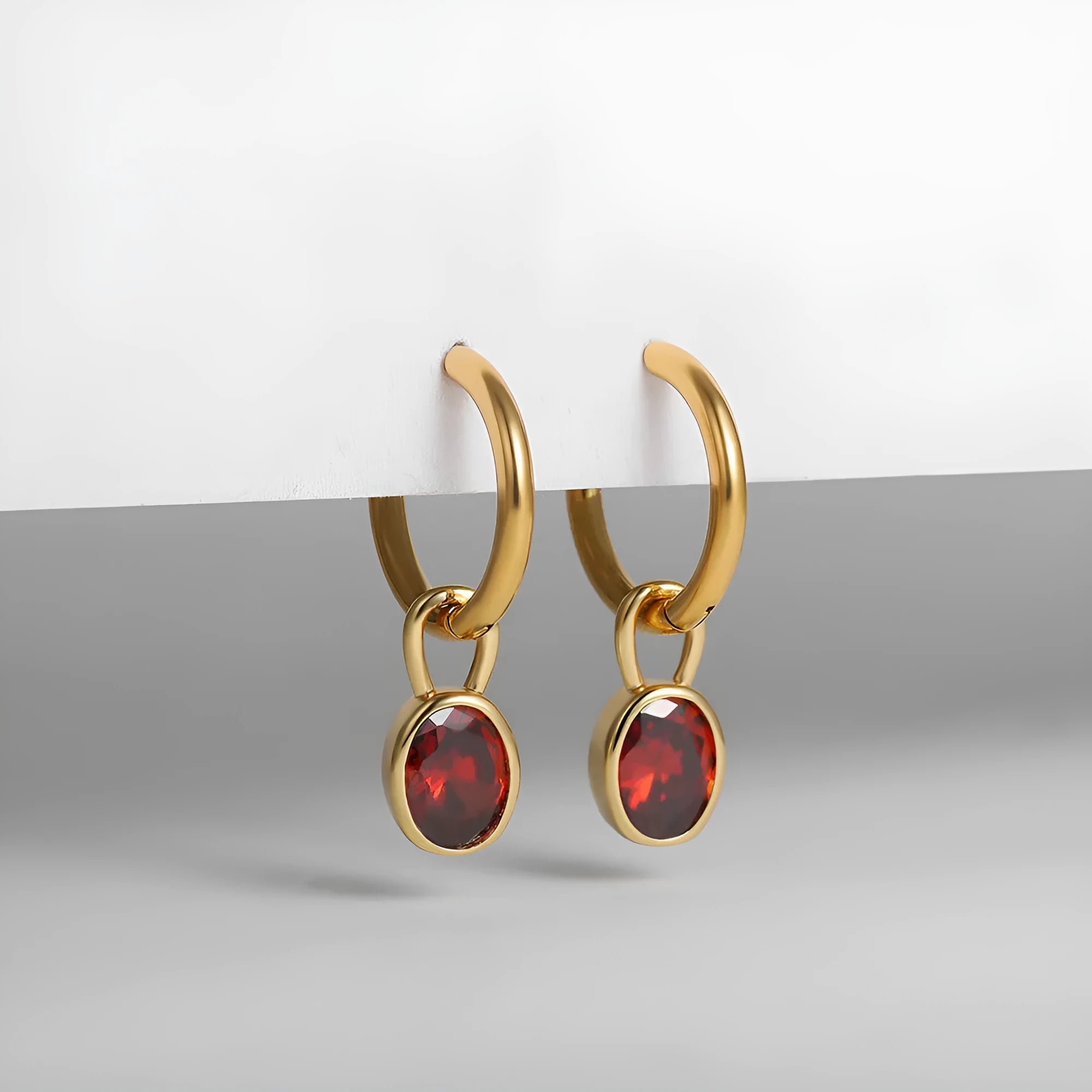 A pair of women's retro-style oval zircon stud earrings in copper, showing one of the six available stone colour options.