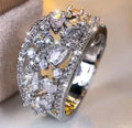 Women's hollow round copper fashion ring with gemstone, shown in gold and platinum colour options.
