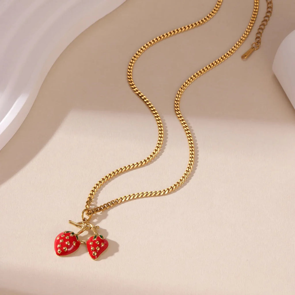 Women's strawberry fruit pendant necklace in red and white gradient colours on an alloy chain.