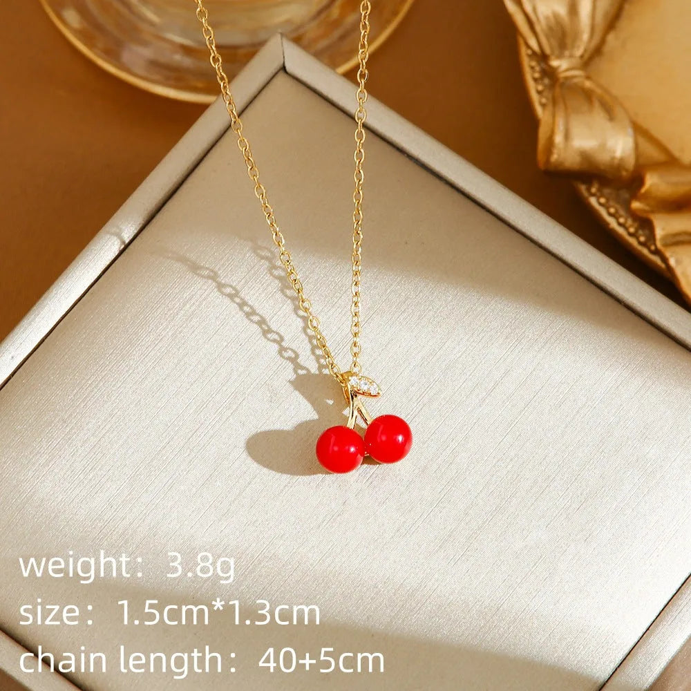 Close-up of a titanium steel necklace with an indie-style cherry pendant on an O-ring chain.