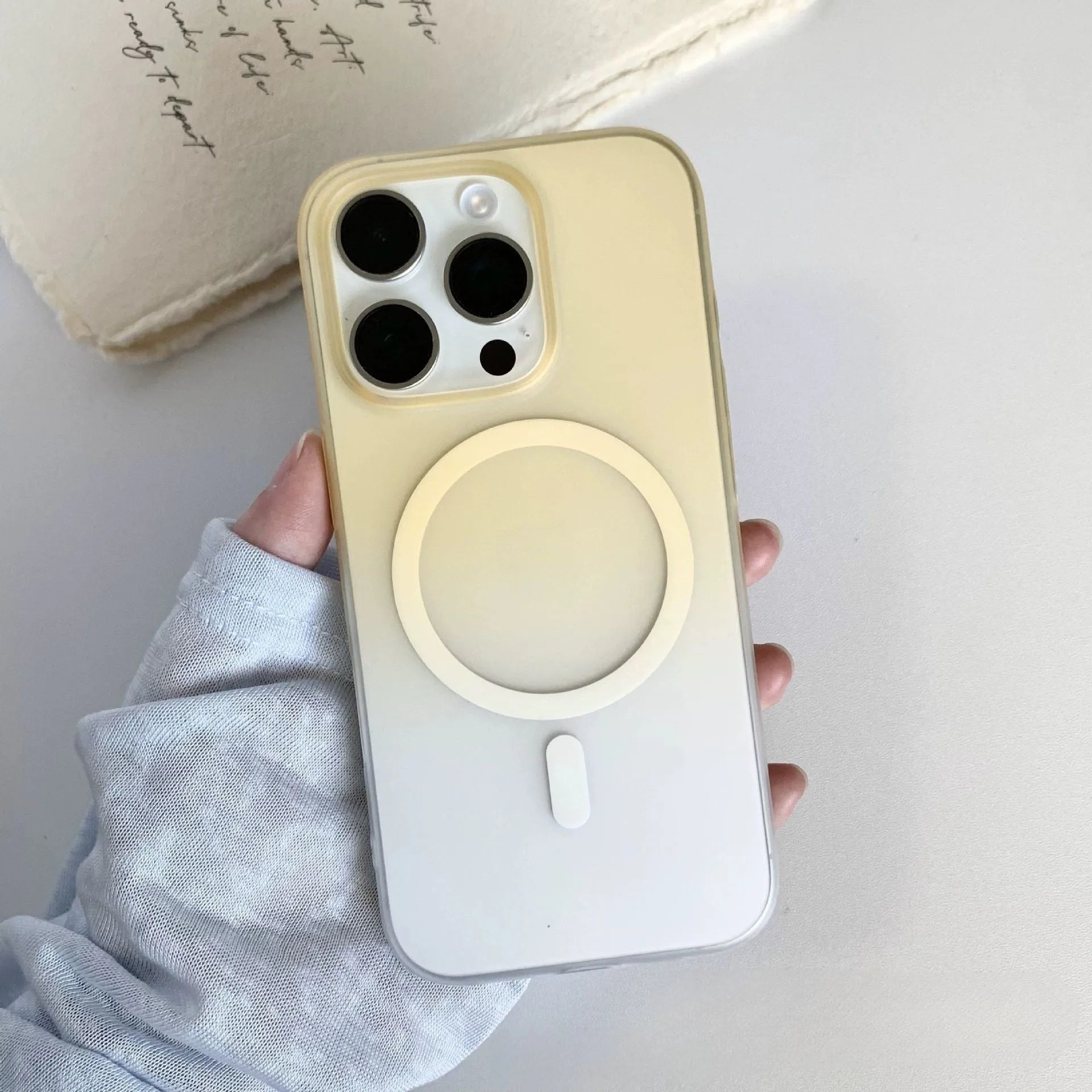 Gradient coloured frosted magnetic suction case for iPhone on a table