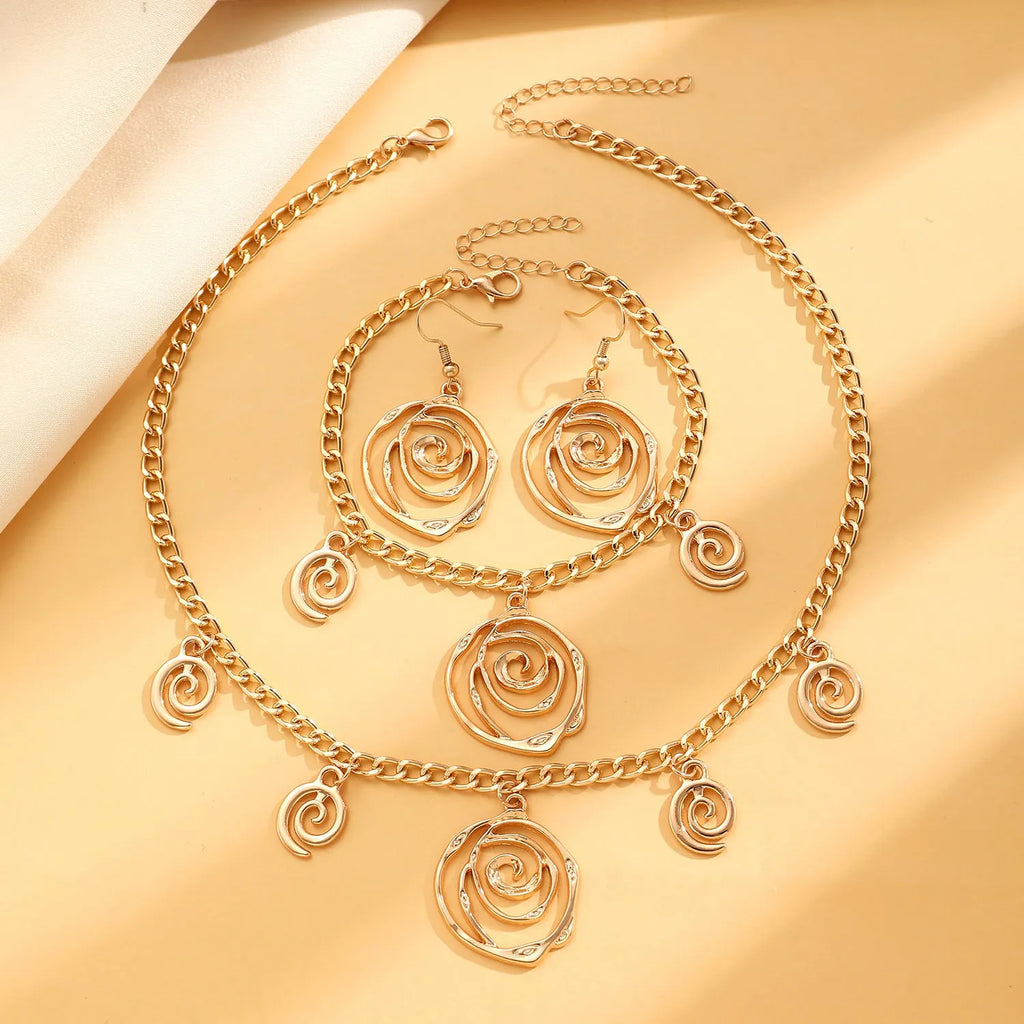 Spiral donut design women's jewellery set showing necklace, bracelet and ear hooks in gold or silver finish