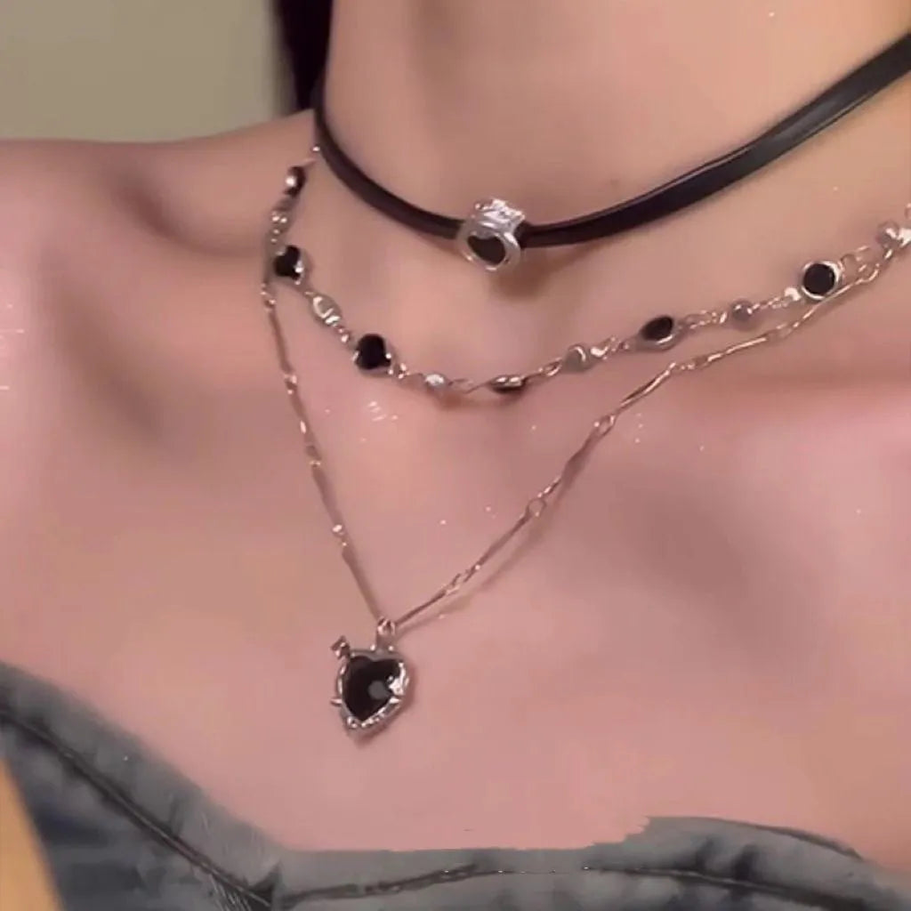 Close-up of a women's multi-layer heart necklace with a leather pendant on an adjustable alloy chain.