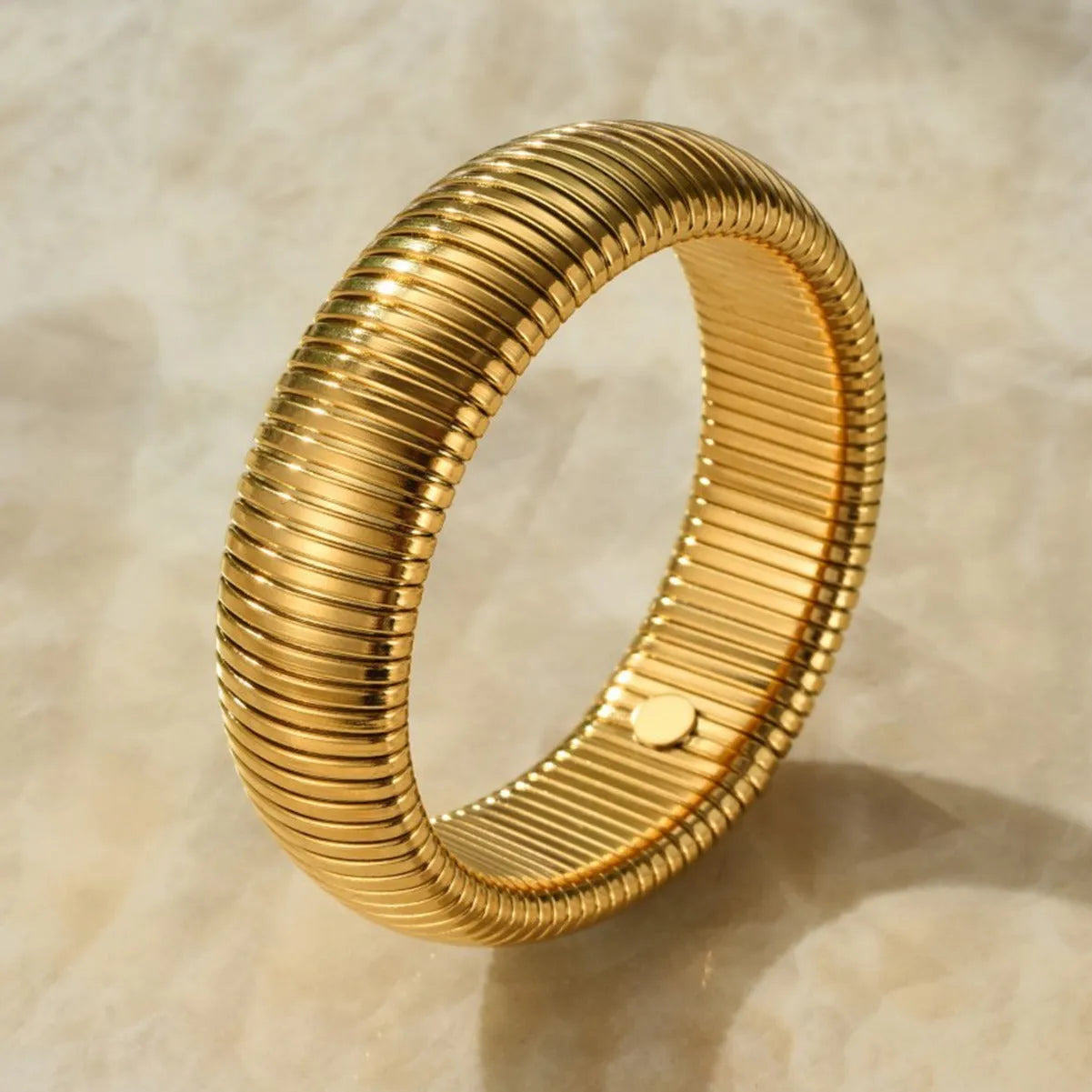 Women's titanium steel bracelet with vertical stripe pattern in gold or silver, available in 0.8cm to 2.0cm widths