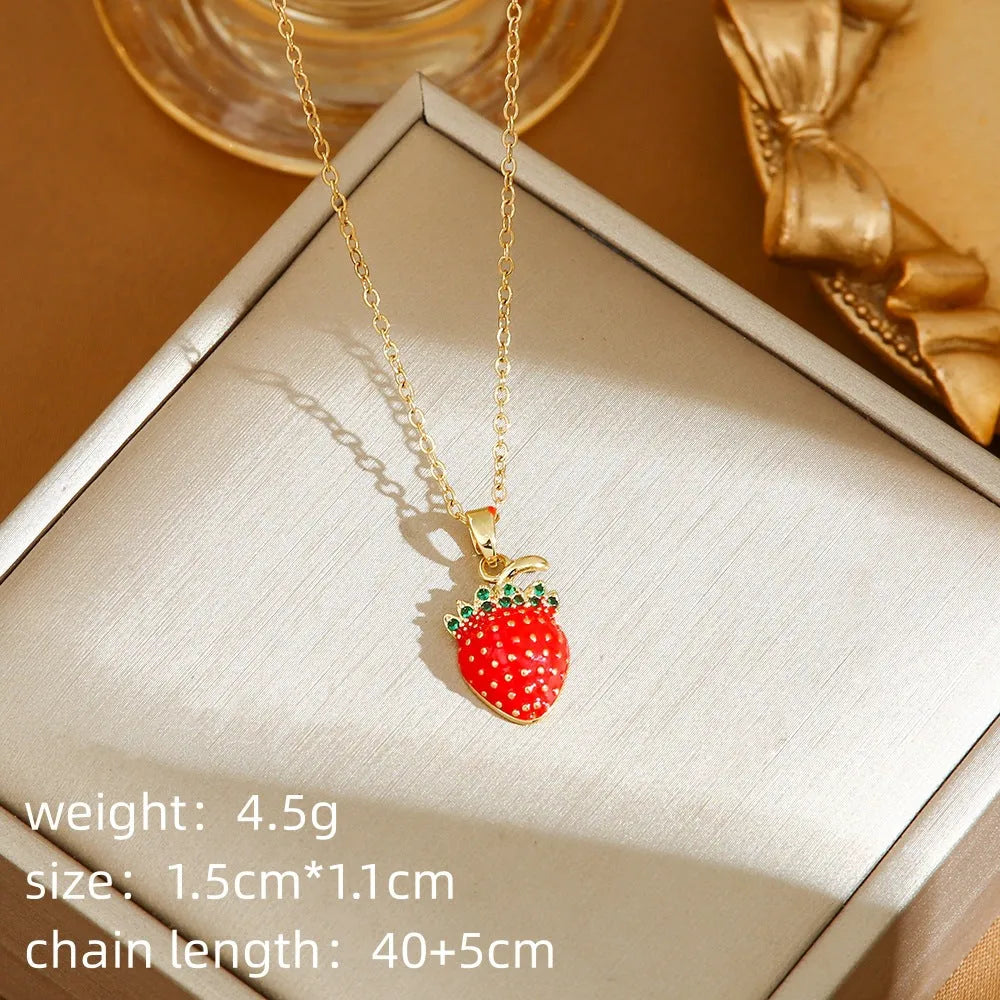 Close-up of a titanium steel necklace with an indie-style cherry pendant on an O-ring chain.