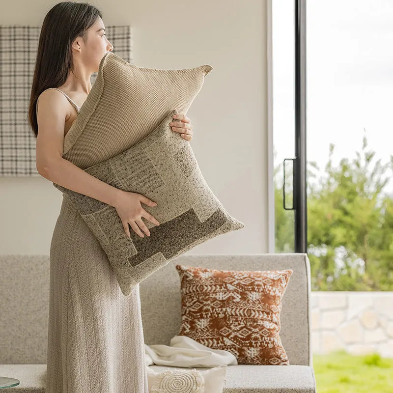 Coreless pillow cushion with pp cotton filler in solid colours on a sofa.