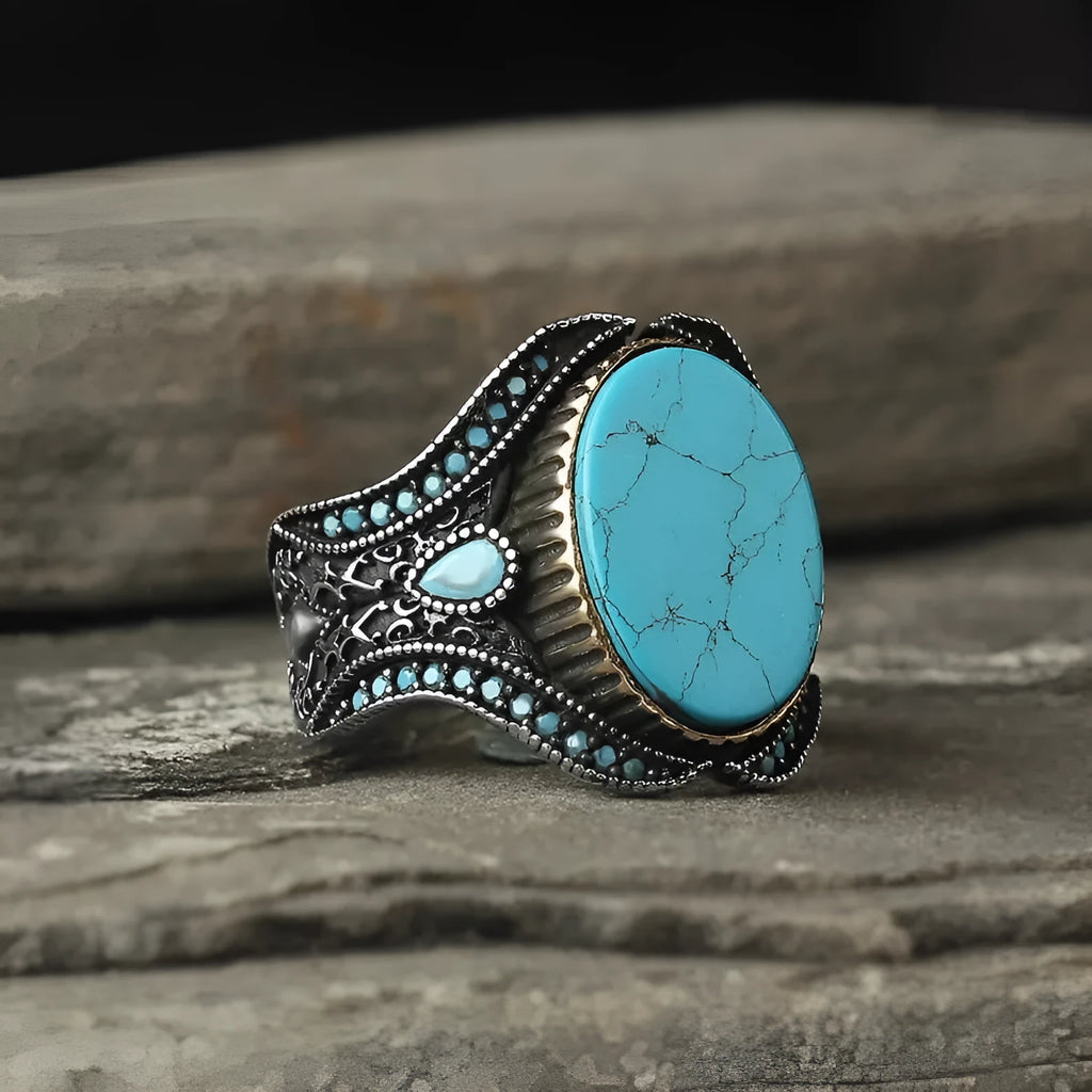 Men's round turquoise ring with antique silver metal band, shown in size 10.
