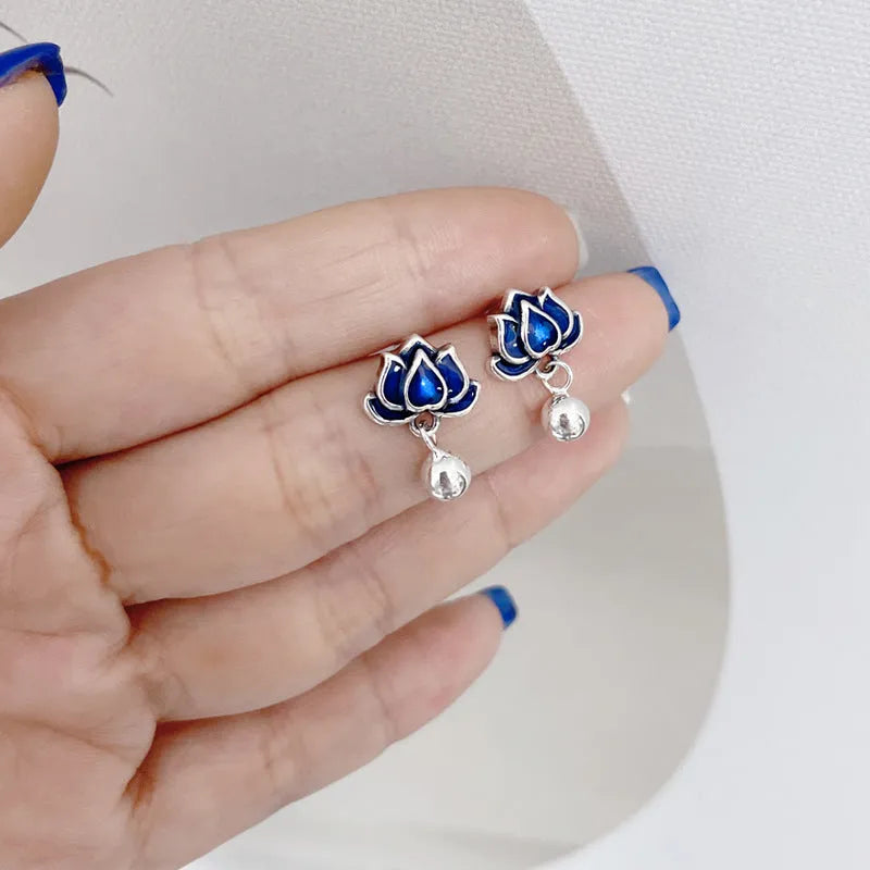 Blue lotus flower ear studs with seedpod tassel detail, silver alloy construction.