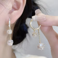 Silver drop earrings for women with a tassel ball and rhinestone ball pendant design.