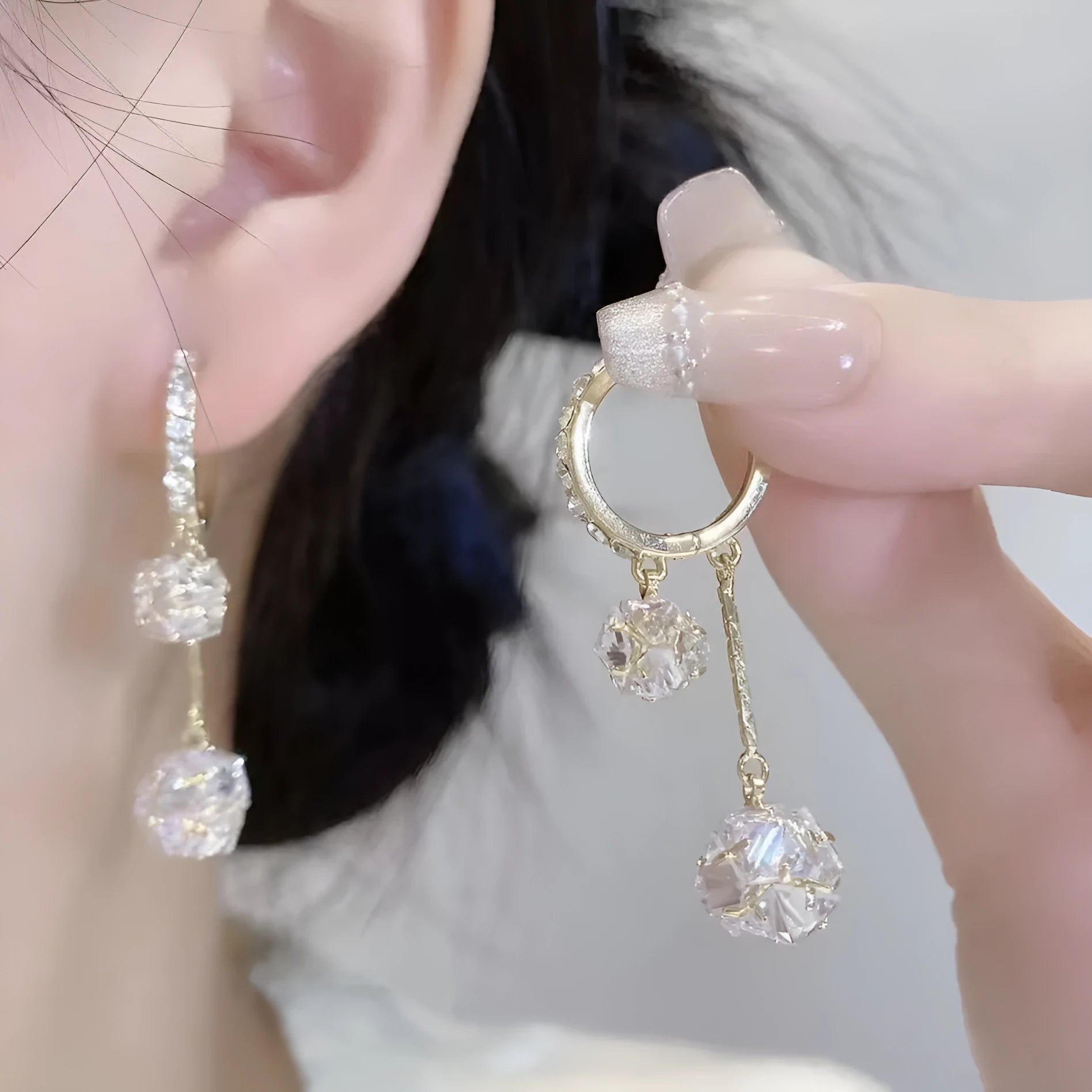 Silver drop earrings for women with a tassel ball and rhinestone ball pendant design.
