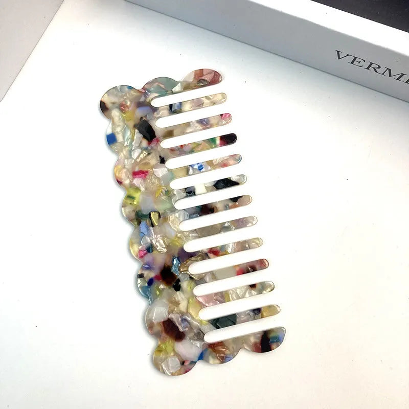 Acetate board hair comb with geometric wave design in a selection of colours.