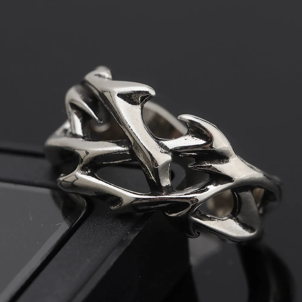 Copper adjustable ring with geometric thorn and flower design on a hand.