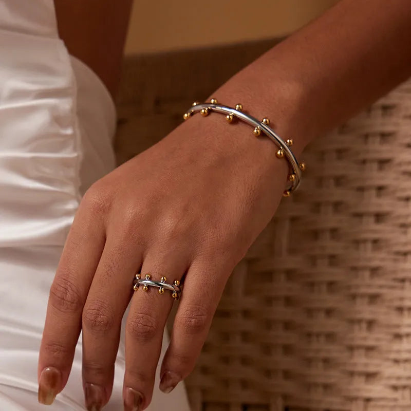 Stainless steel C-shaped ring with textured rivet bean beads and alloy bracelet in gold finish