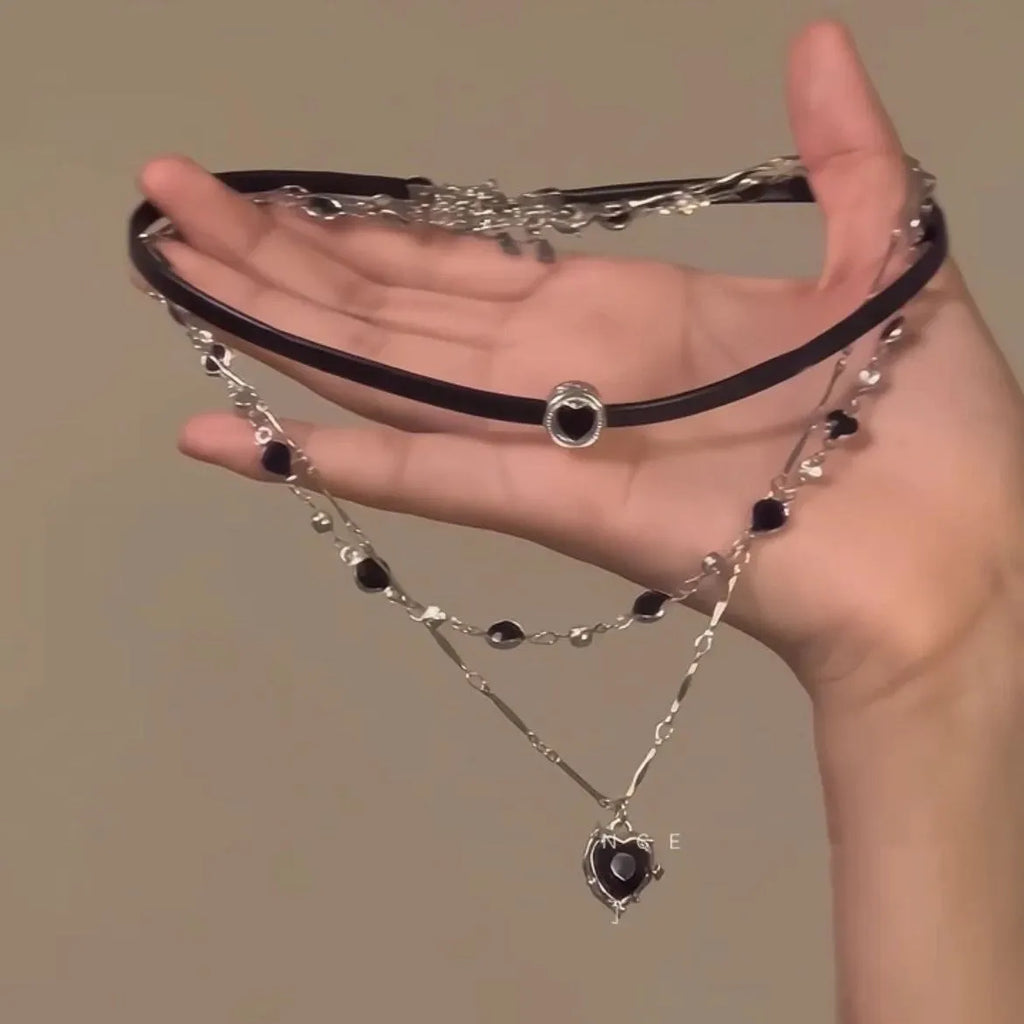 Close-up of a women's multi-layer heart necklace with a leather pendant on an adjustable alloy chain.