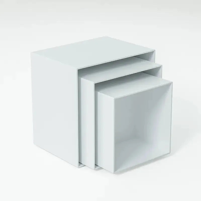 White and transparent plastic suit cube dessert display stands arranged in a tiered formation.