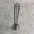 Black wrought iron coffee capsule storage rack holding pods on a kitchen counter
