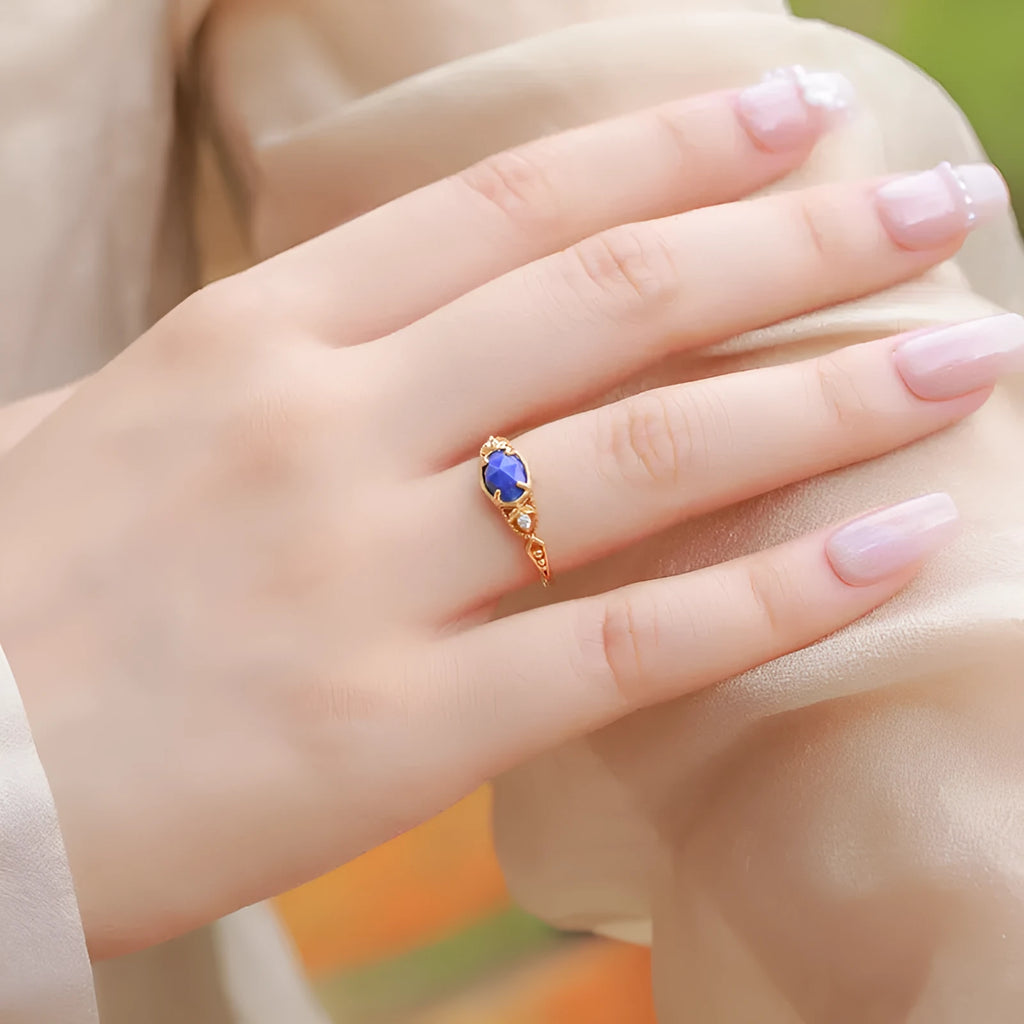 Women's sterling silver ring with a blue lapis lazuli stone in an ellipse shape.