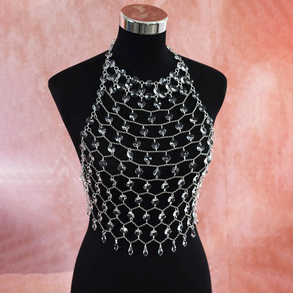 Hand-woven transparent acrylic sequinned plastic resin body chain draped flat.