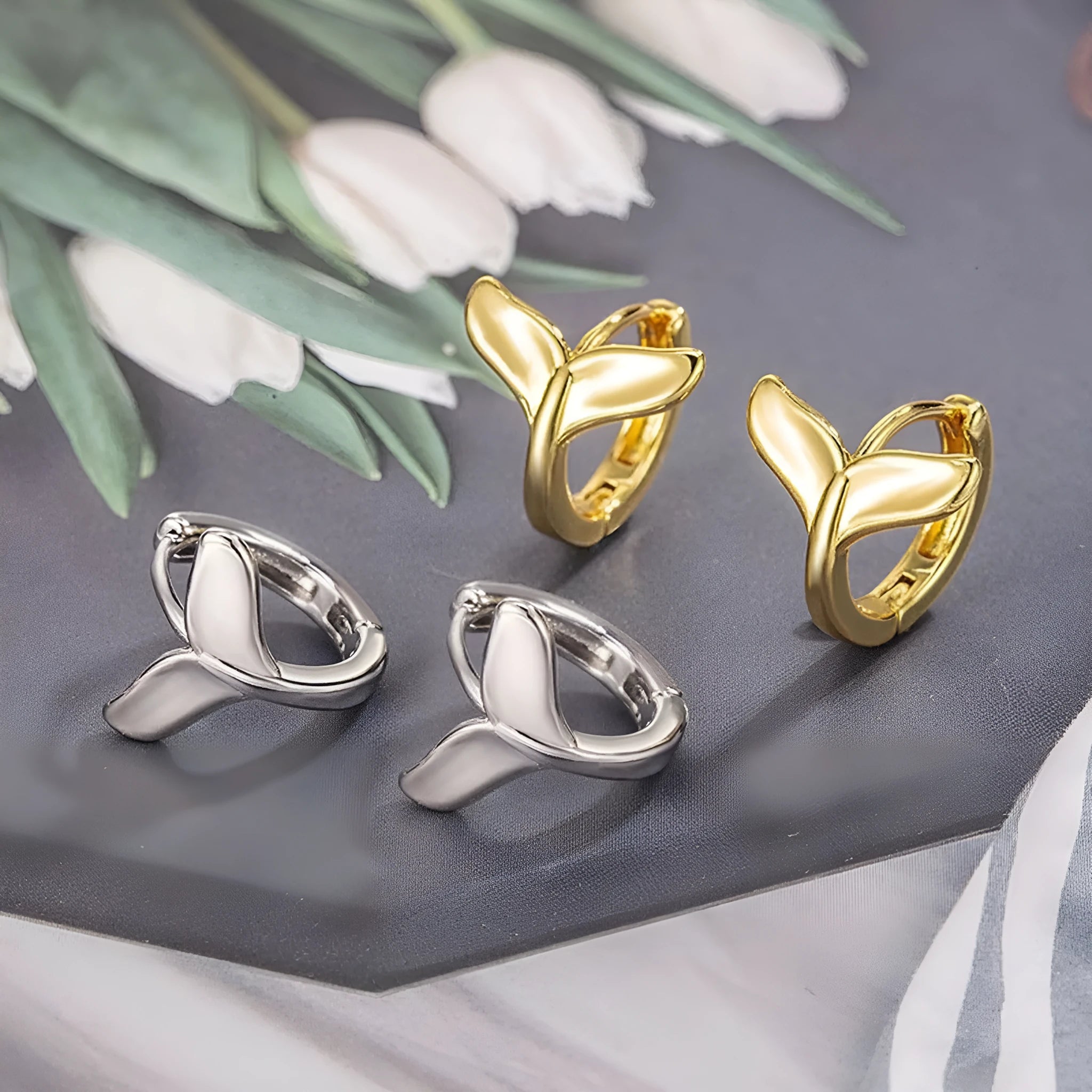 Women's fishtail design earrings in electroplated copper available in white gold or yellow gold colour