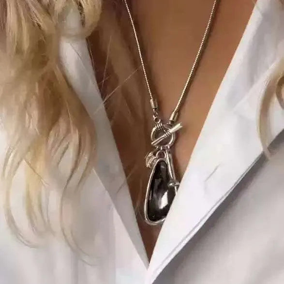 Women's long alloy necklace with geometric pendant and snake bones chain in blue, champagne, or grey.