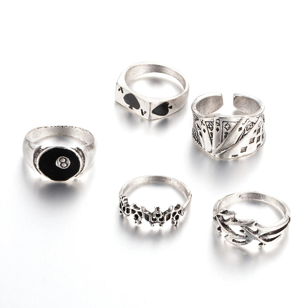 Black alloy poker ring with a retro spade card design on a finger.