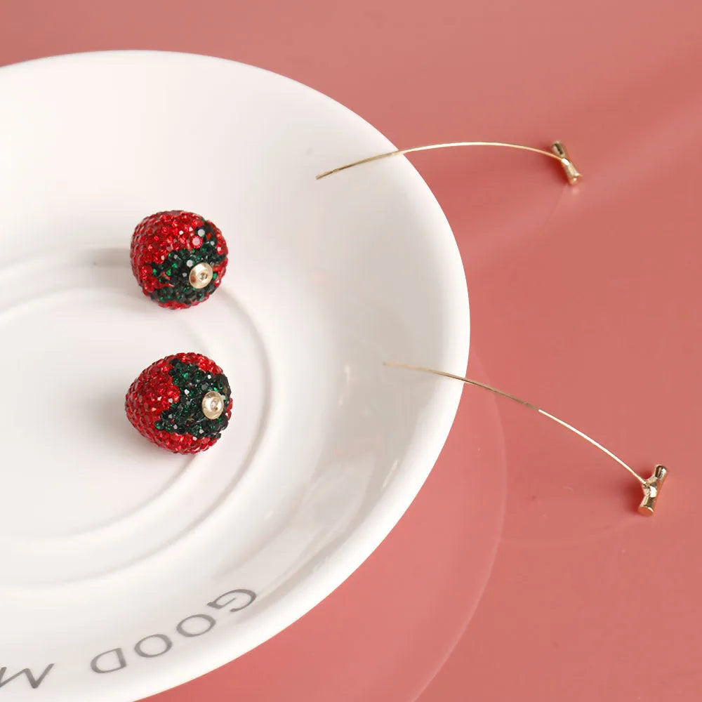 Red zinc alloy strawberry earrings with geometric shape and spot drill texture.