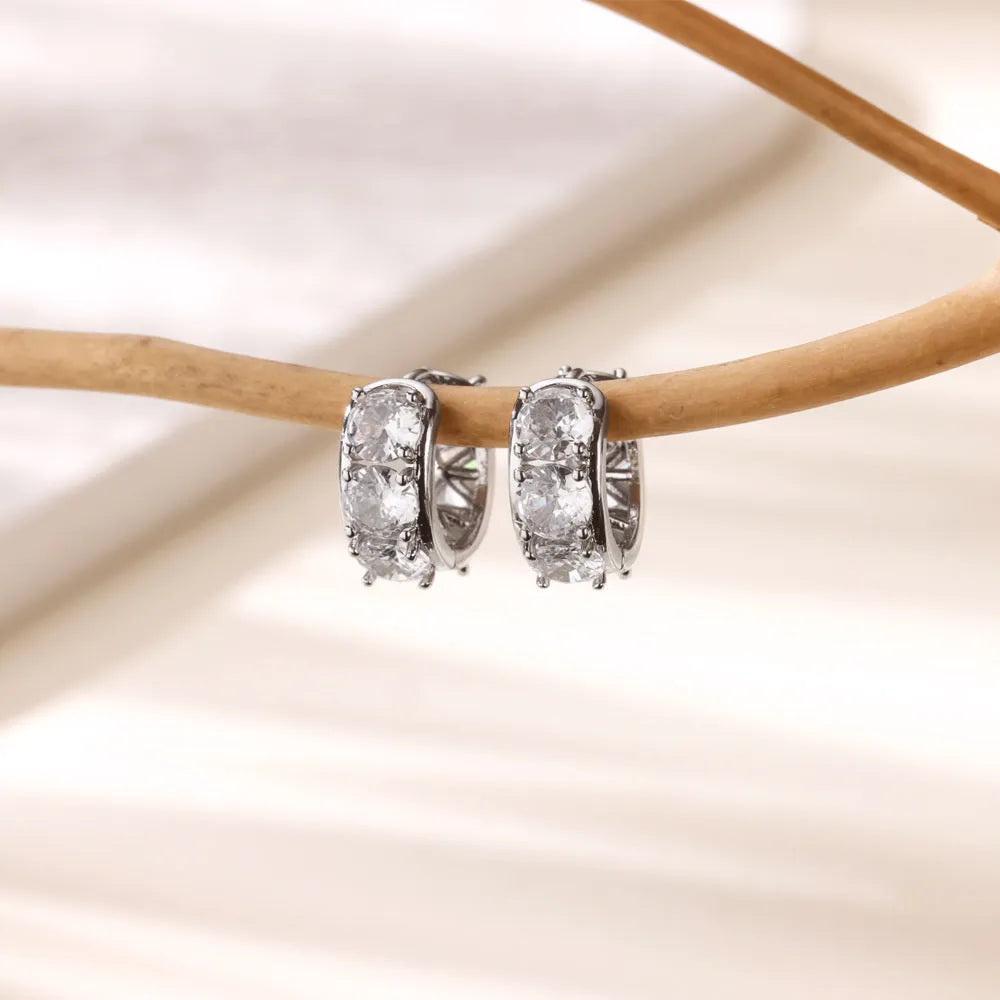 Gold-tone stainless steel U-shaped women's clip earrings with sparkling zircon accents.