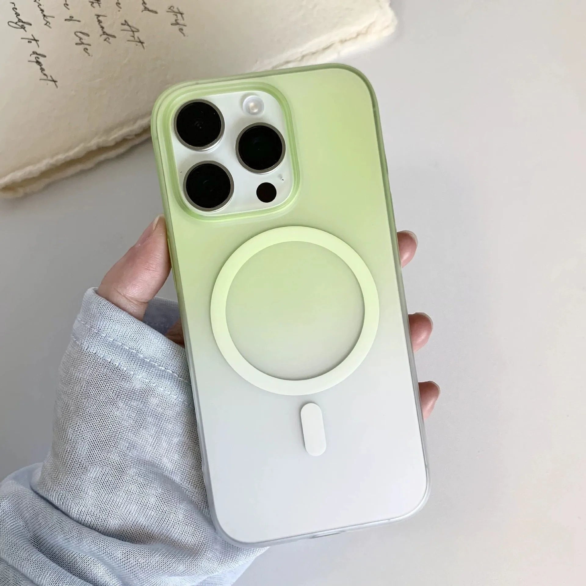 Gradient coloured frosted magnetic suction case for iPhone on a table