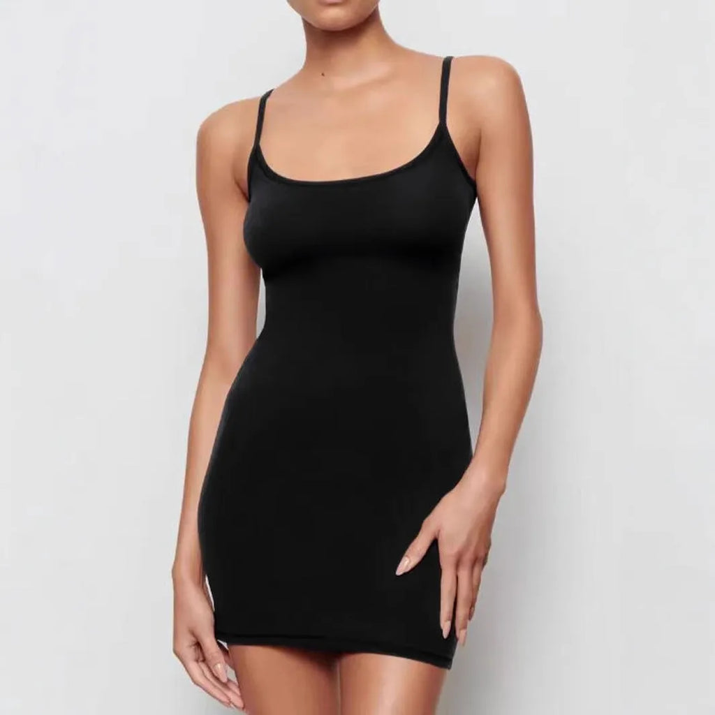 Black sleeveless sling dress with a skinny sheath silhouette and short skirt.