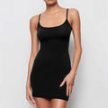 Black sleeveless sling dress with a skinny sheath silhouette and short skirt.
