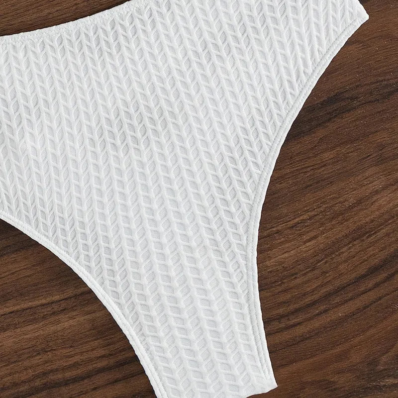 White backless women's bikini swimsuit with briefs style on mannequin
