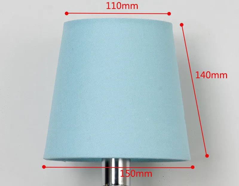 Modern minimalist fabric drum lampshade in a mini size on a table lamp base.