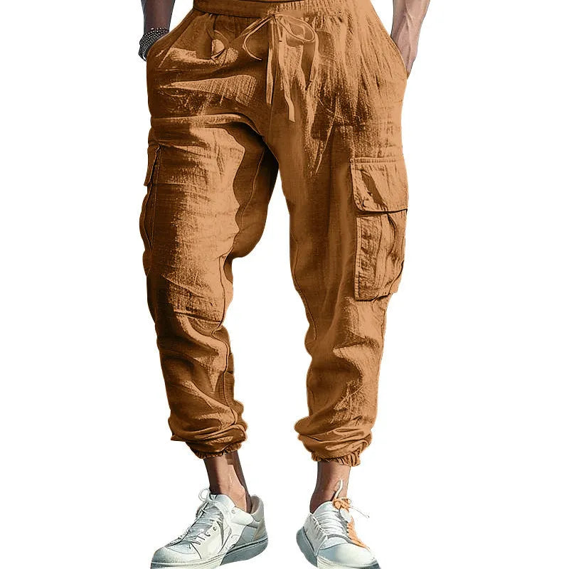 Men's loose-fit linen casual trousers with ankle ties and multiple pockets in a solid colour.
