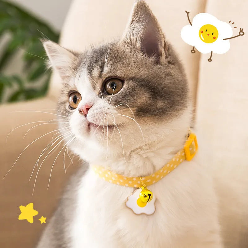 Adjustable green cat collar with a metal bell pendant and a matching bow tie decoration.